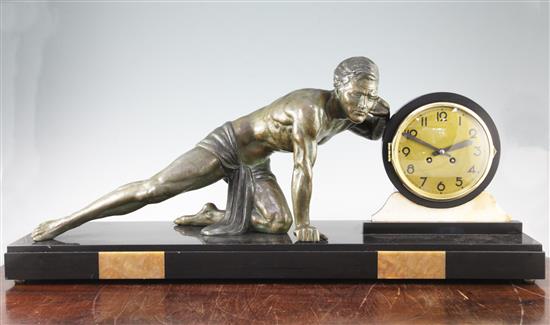A French Art Deco marble figural mounted clock, 33in.